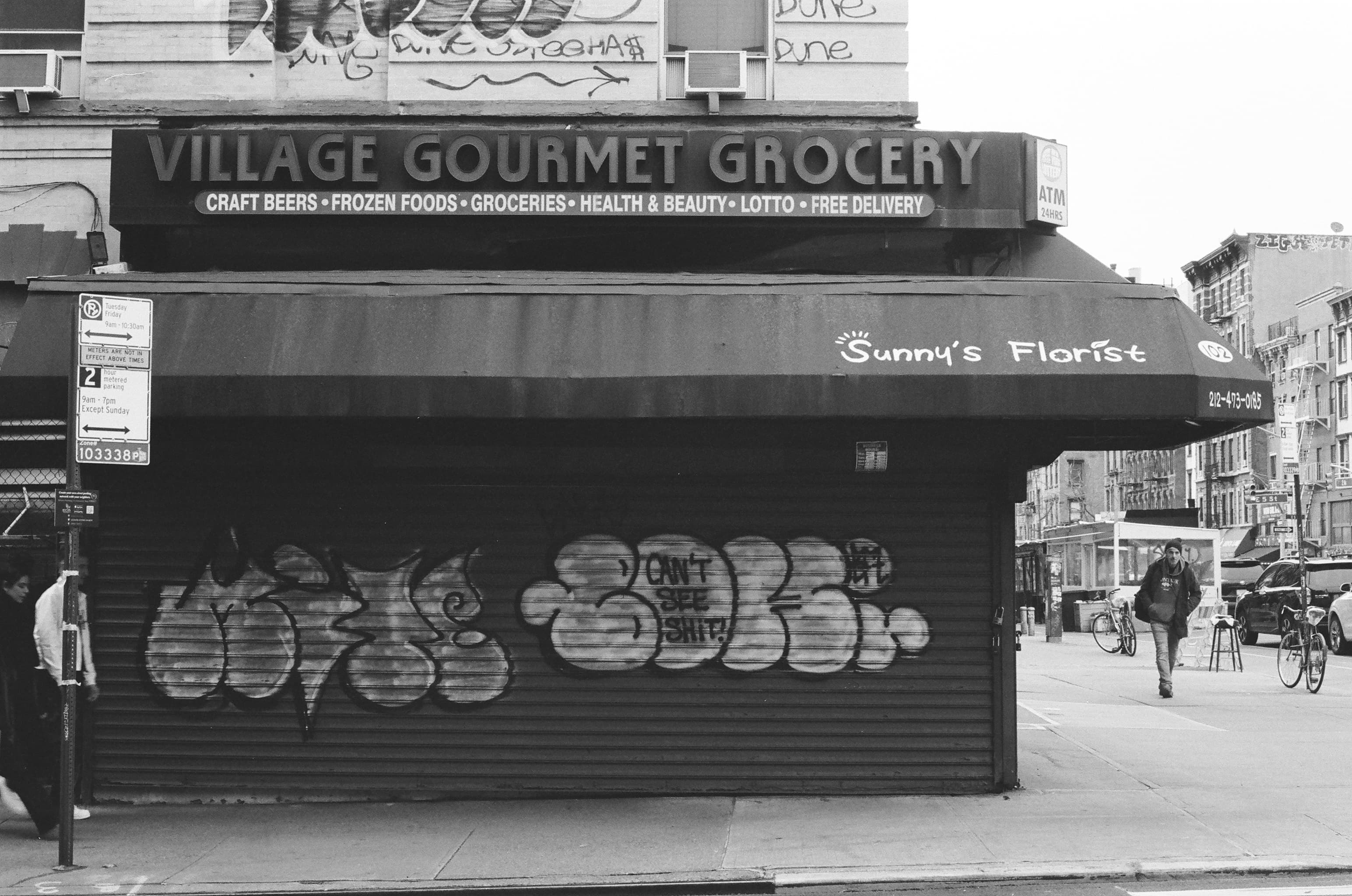 A florist shop on the side of a bodega in New York City.