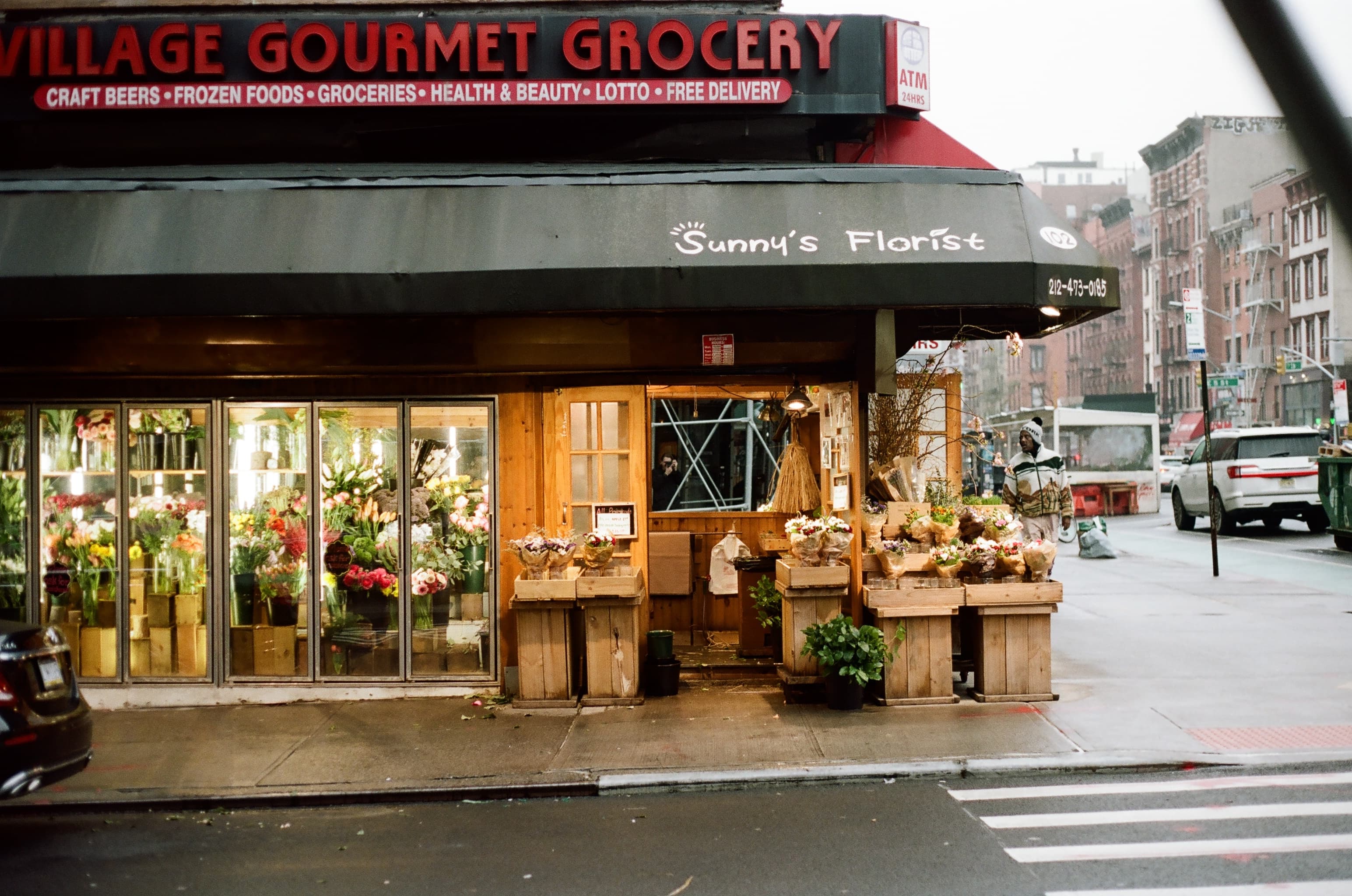 A florist shop on the side of a bodega in New York City.