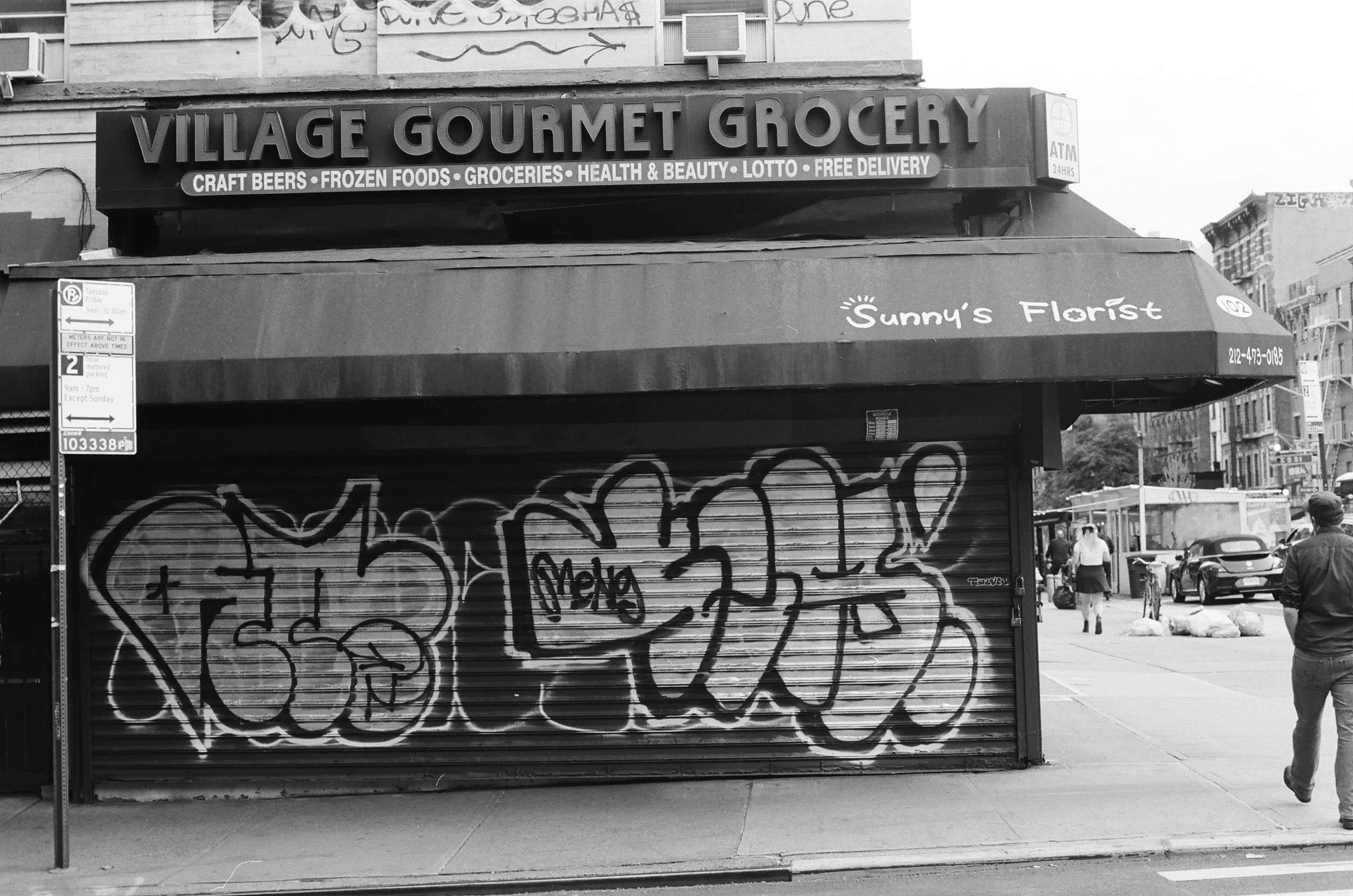 A florist shop on the side of a bodega in New York City.